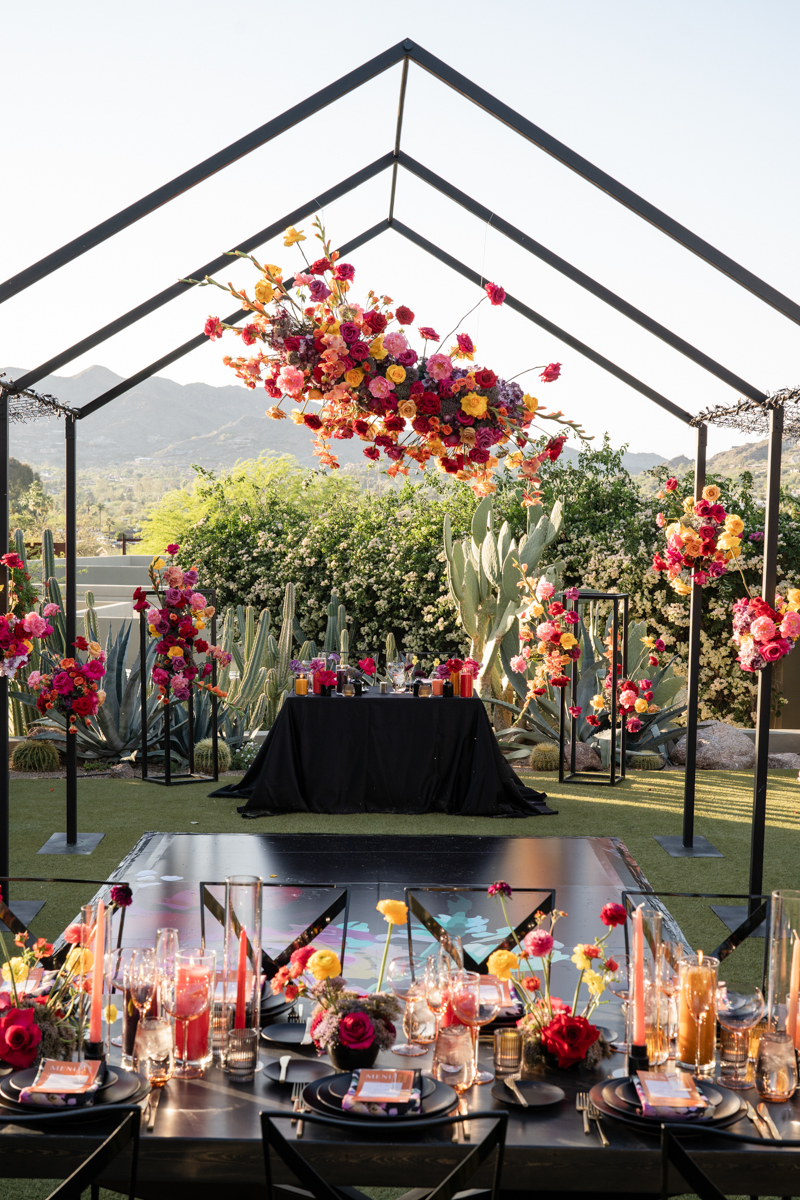 colorful desert wedding with black tent structure