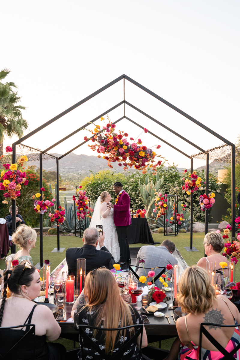 colorful desert wedding with black tent structure