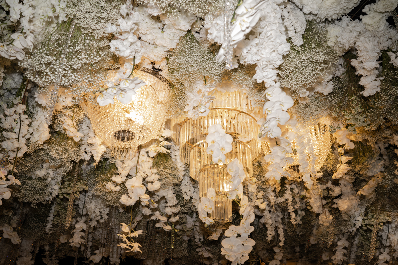 chandelier and floral ceiling installation