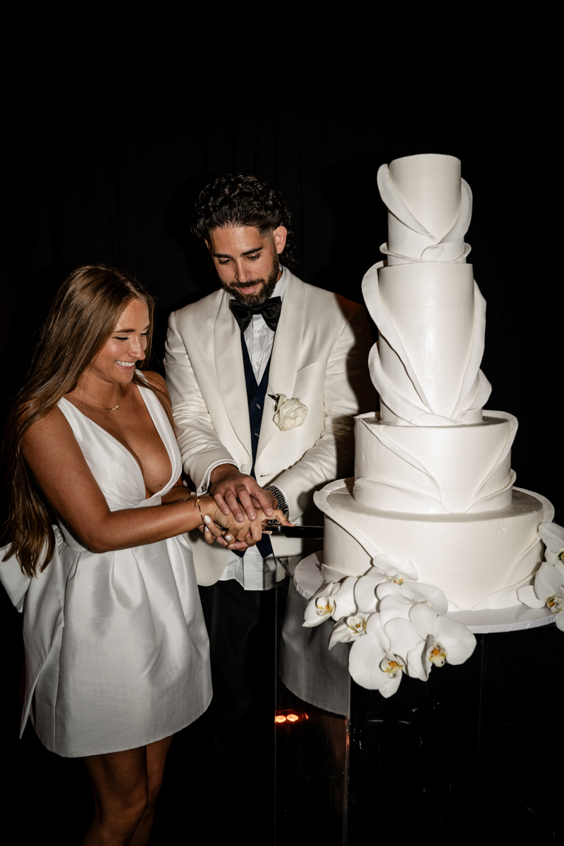 bride and groom cutting cake