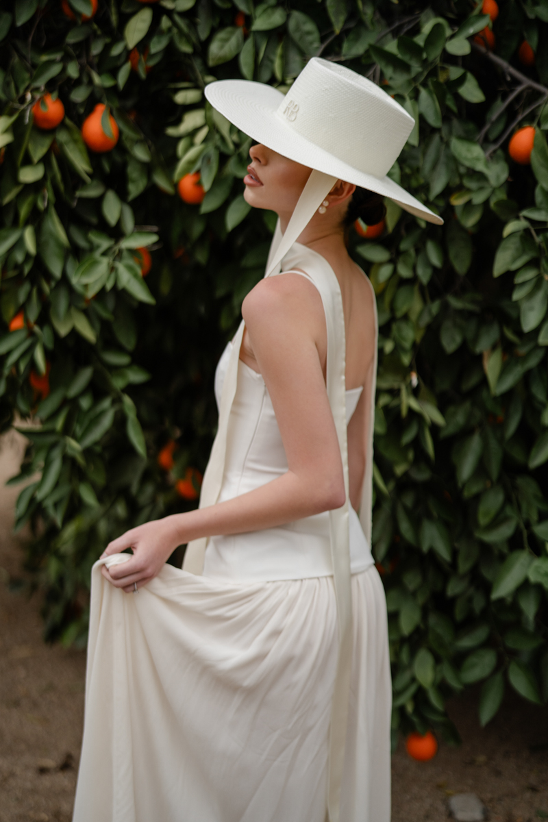 bridal hat fashion in front of orange tree